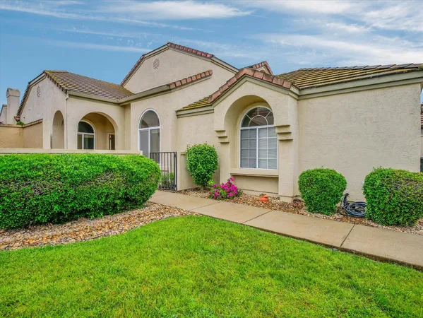 a front view of a house with a garden