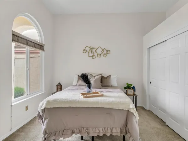 a bed sitting in a bedroom next to a window