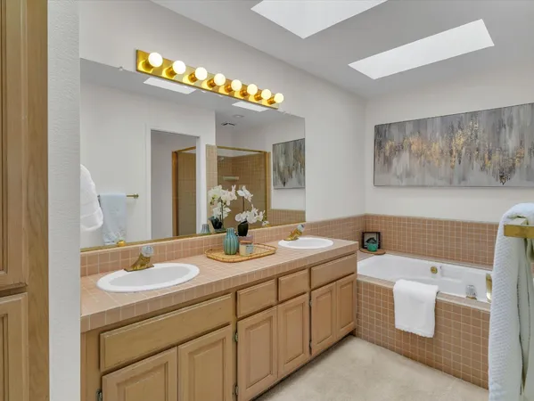 a bathroom with a sink a vanity and a mirror