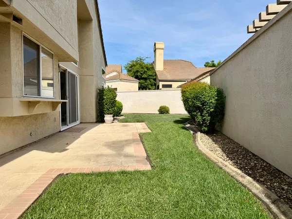 a view of a patio with furniture and a potted plants
