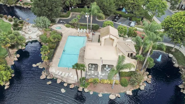 an aerial view of a house with a yard basket ball court and outdoor seating