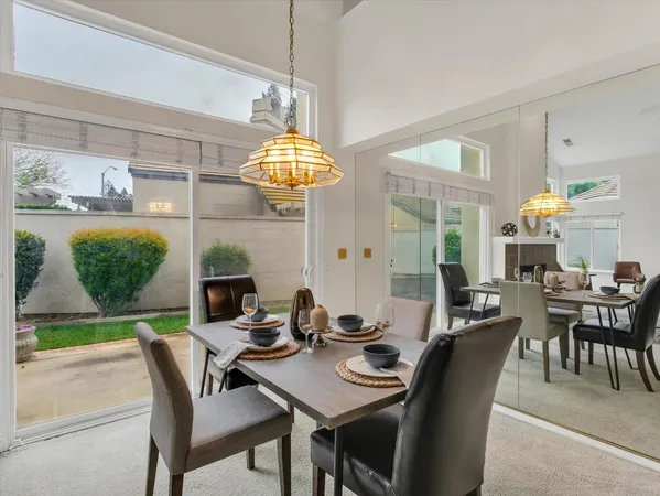 a view of a dining room with furniture and chandelier