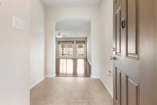 view of an empty room with wooden floor and a window