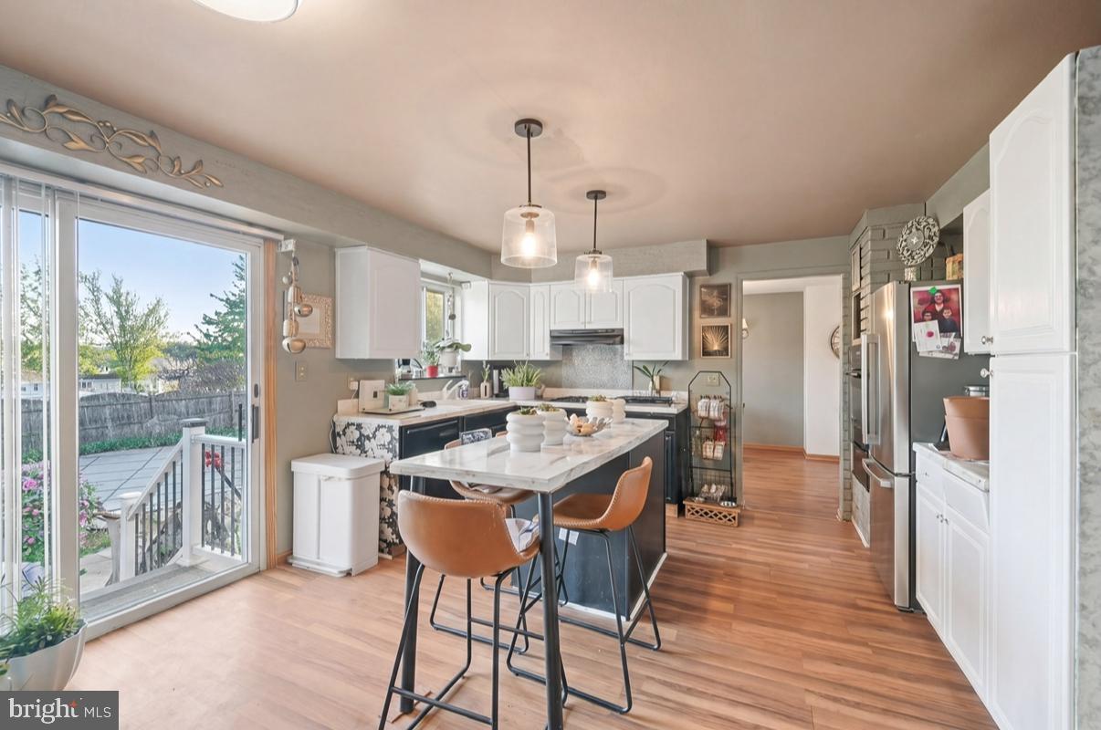 24 Castor Court Sewell, NJ 08080 - Photo 2 of 19 a kitchen with stainless steel appliances granite countertop a refrigerator a sink dishwasher a stove and white countertops with wooden floor