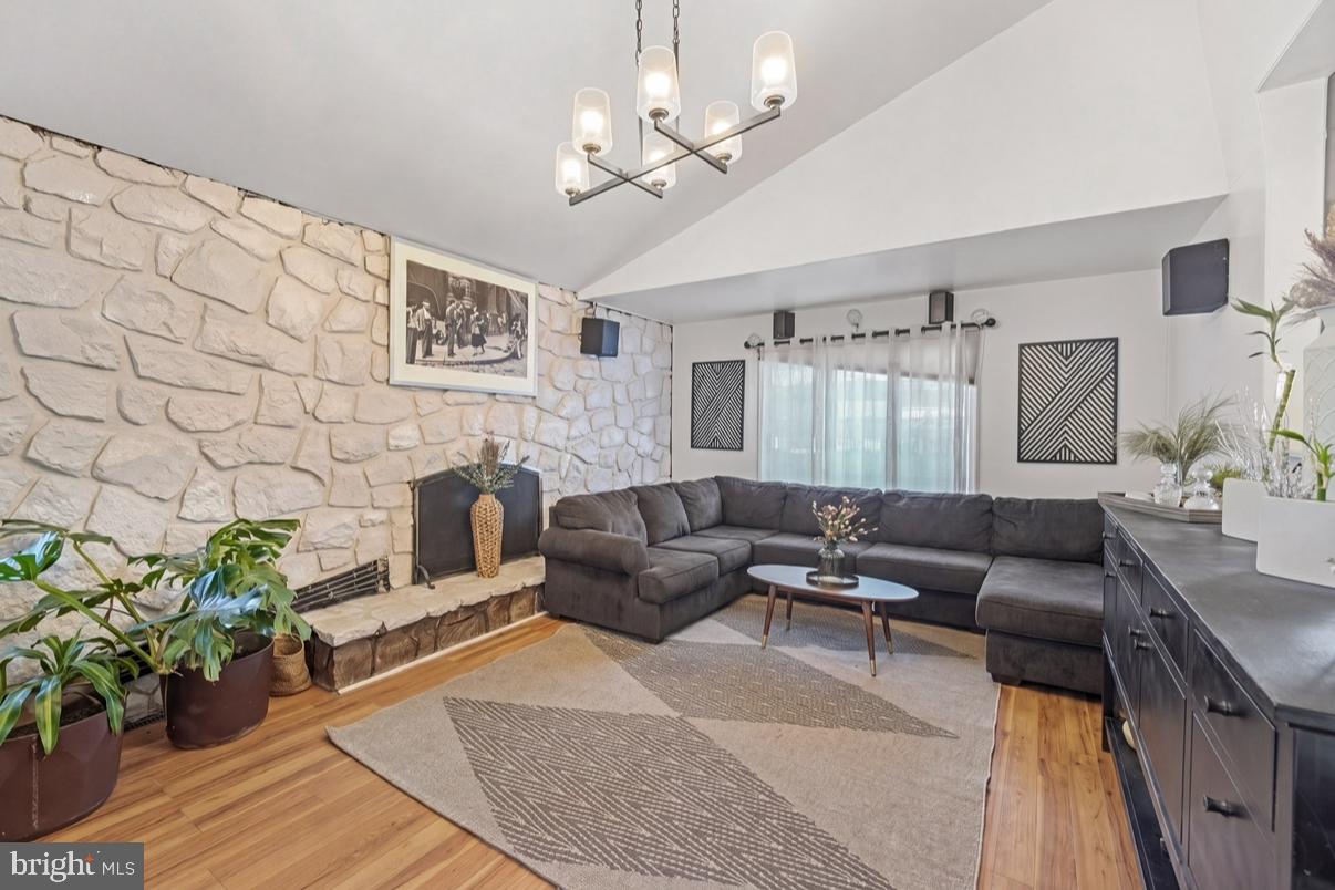24 Castor Court Sewell, NJ 08080 - Photo 5 of 19 a living room with furniture a chandelier and a fireplace