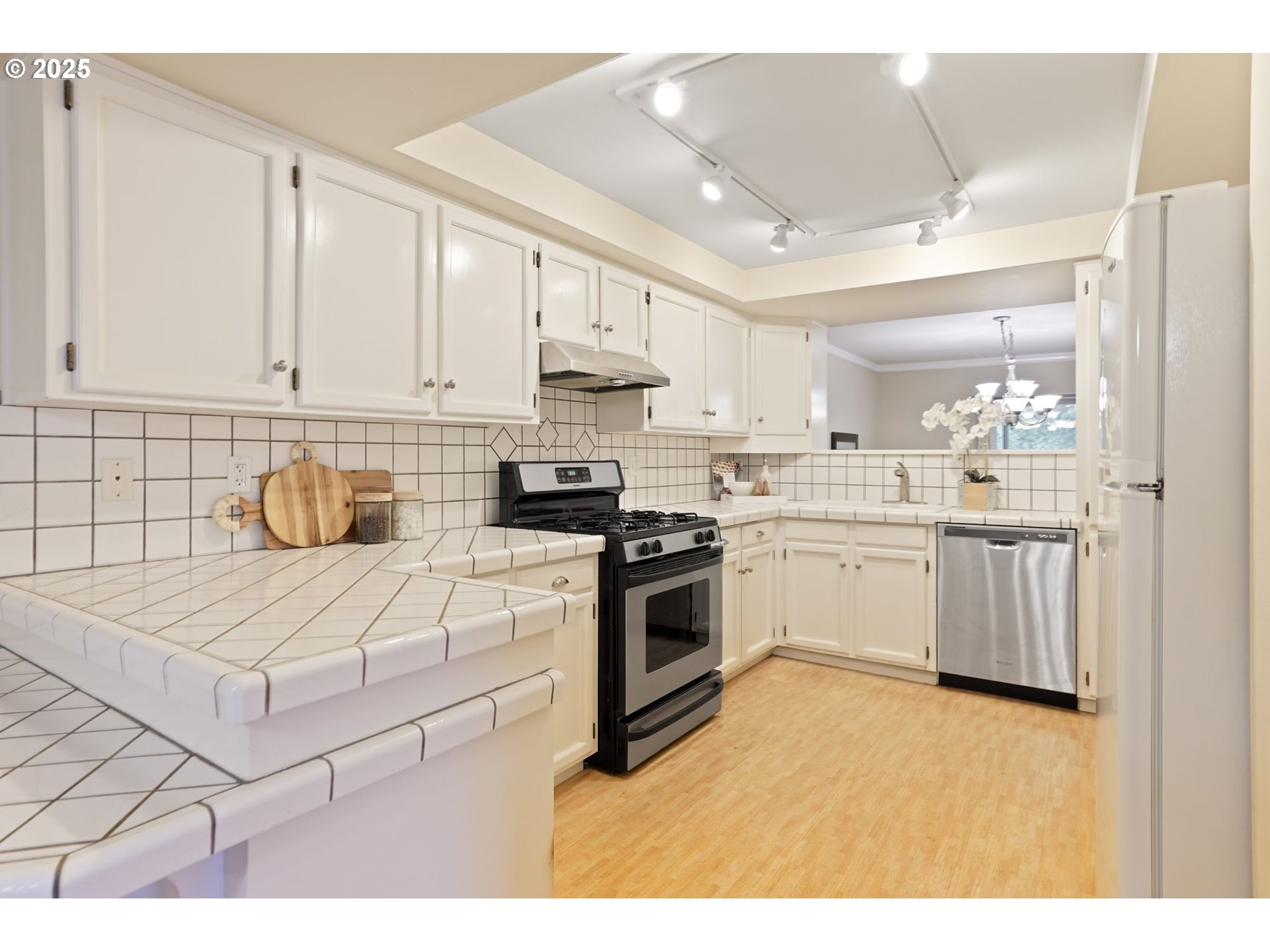 6679 Huntington Circle Southeast Salem, OR 97306 - Photo 13 of 45 a kitchen that has a lot of white cabinets and stainless steel appliances