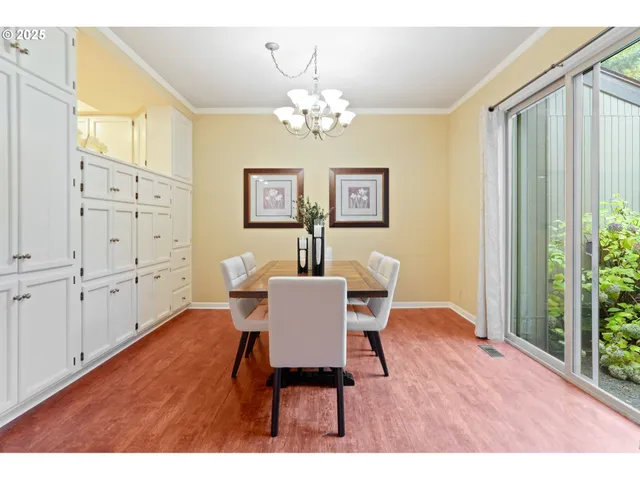 a view of a dining room with furniture and chandelier