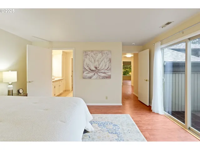 a bedroom with a bed and a painting on the wall