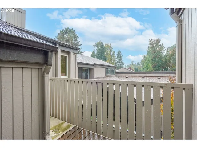 a view of a house with a wooden fence