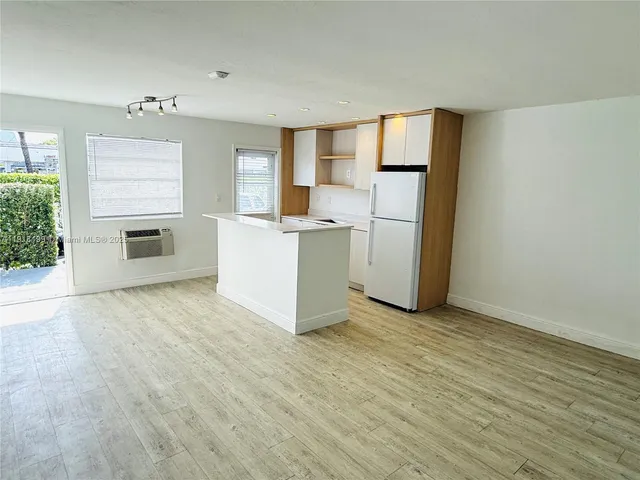 a view of a kitchen with a stove cabinets and a wooden floor