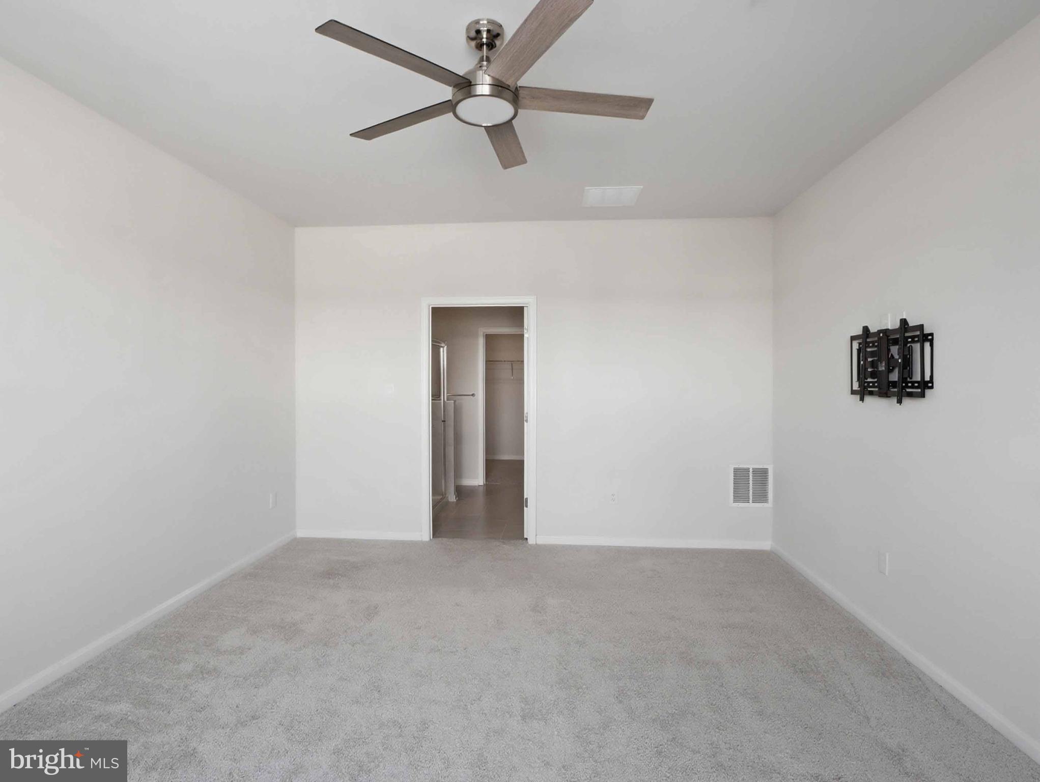 485 Hanson Street Frederick, MD 21701 - Photo 17 of 48 an empty room with a ceiling fan and a window