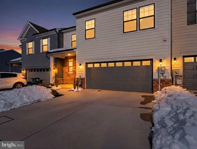 a view of a house with snow on the side of the road