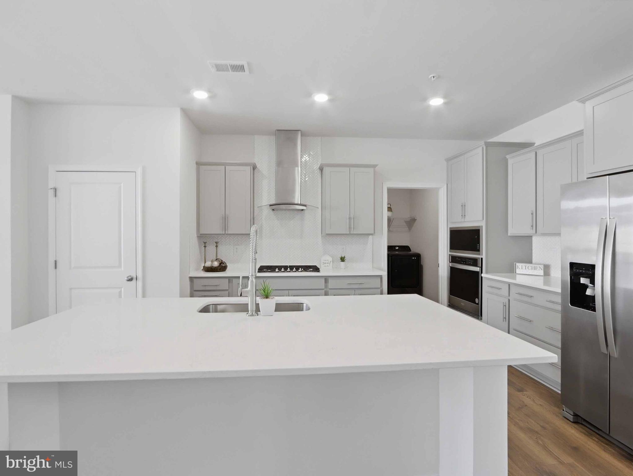 485 Hanson Street Frederick, MD 21701 - Photo 7 of 48 a kitchen with kitchen island a white cabinets and refrigerator