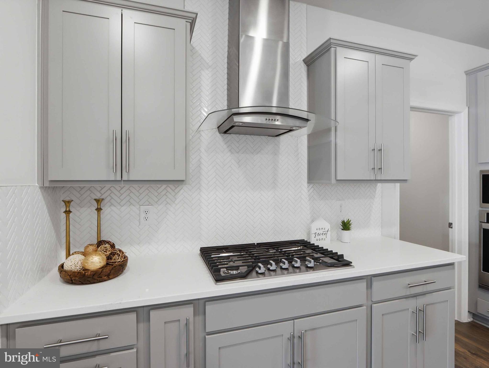 485 Hanson Street Frederick, MD 21701 - Photo 10 of 48 a kitchen with white cabinets and appliances