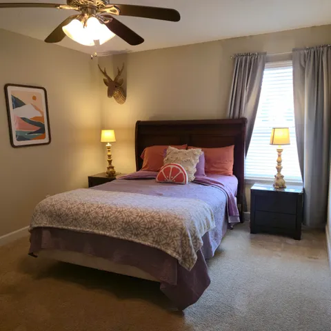 a bedroom with a bed and window