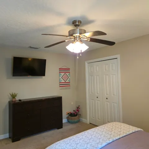 a bedroom with a bed and a flat screen tv
