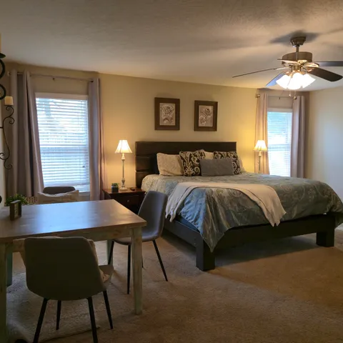 a bedroom with a bed and a table