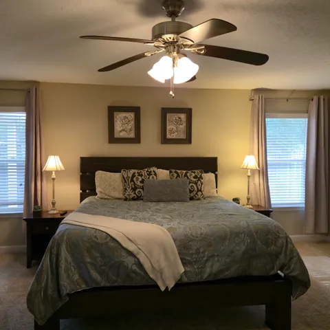 a bedroom with a bed and a chandelier