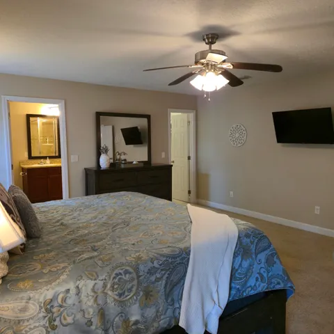 a bedroom with a bed and a chandelier