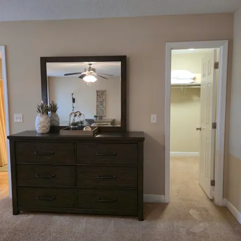 a bathroom with a granite countertop sink vanity and mirror