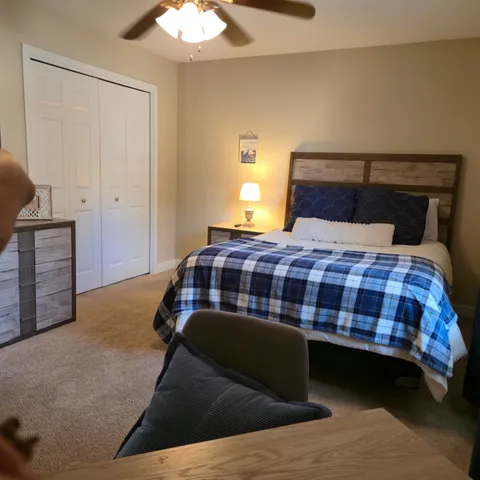 a bedroom with a bed and a chandelier