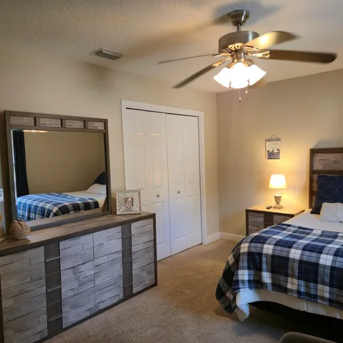 a bedroom with a bed and flat screen tv
