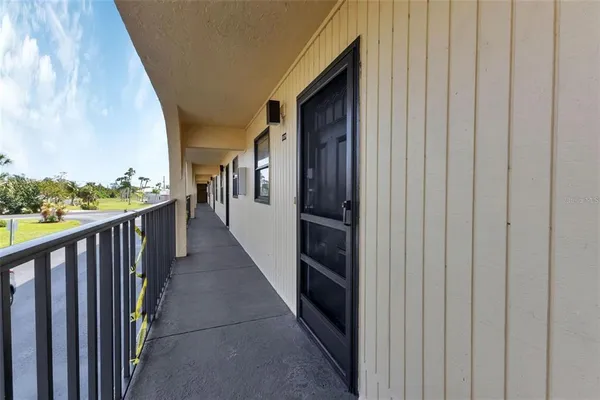 a view of a hallway with wooden floor and fence