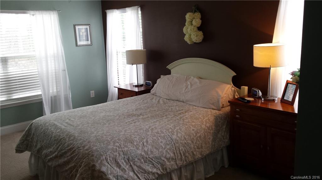230 River Clay Road, Unit 197 Fort Mill, SC 29708 - Photo 8 of 15 a bed sitting in a bedroom next to a window