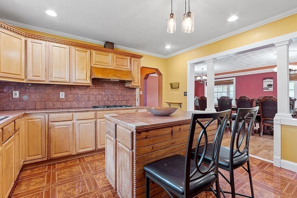 31 Booth Road Methuen, MA 01844 - Photo 11 of 38 a kitchen with stainless steel appliances granite countertop a stove a sink dishwasher and a refrigerator with wooden cabinets