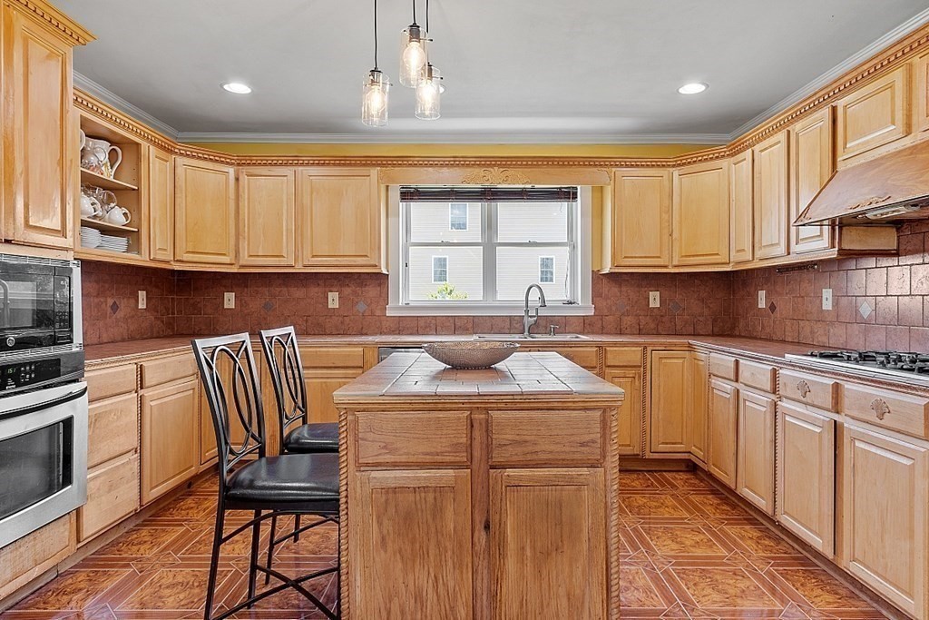 31 Booth Road Methuen, MA 01844 - Photo 13 of 38 a kitchen with stainless steel appliances granite countertop a sink stove and cabinets