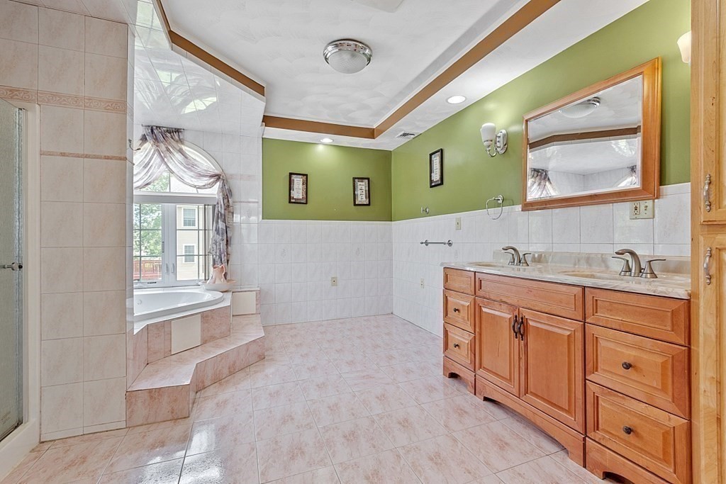 31 Booth Road Methuen, MA 01844 - Photo 20 of 38 a spacious bathroom with a sink a mirror and a bathtub in it