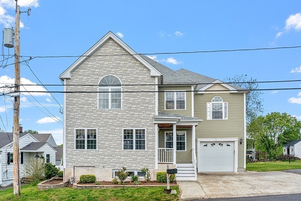 31 Booth Road Methuen, MA 01844 - Photo 2 of 38 a front view of a house with a yard and garage