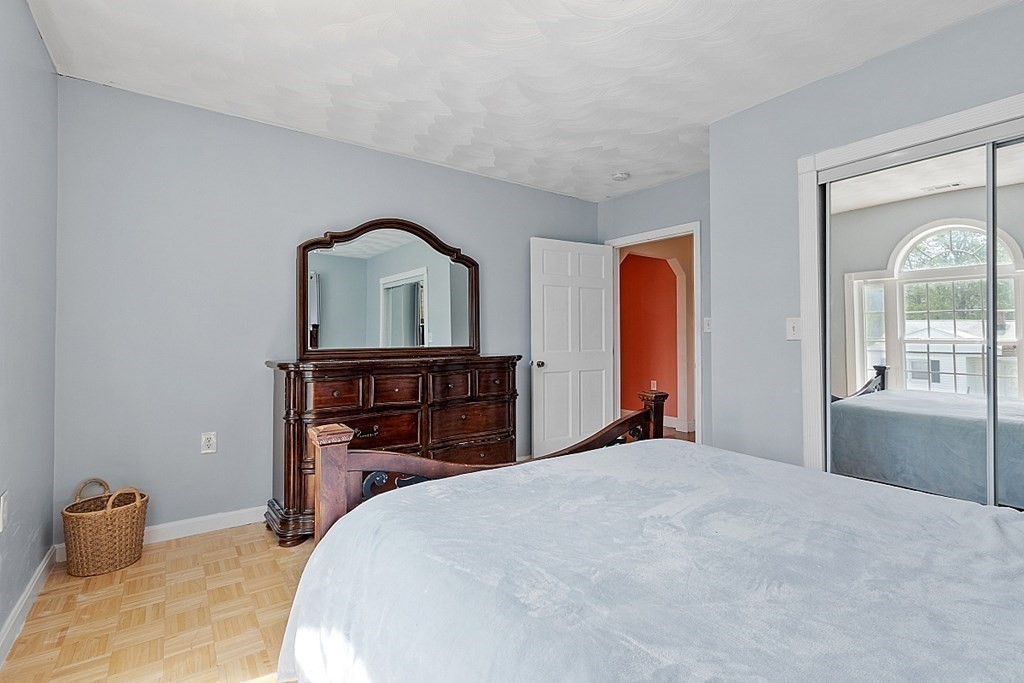 31 Booth Road Methuen, MA 01844 - Photo 26 of 38 a bedroom with a large bed and a chandelier