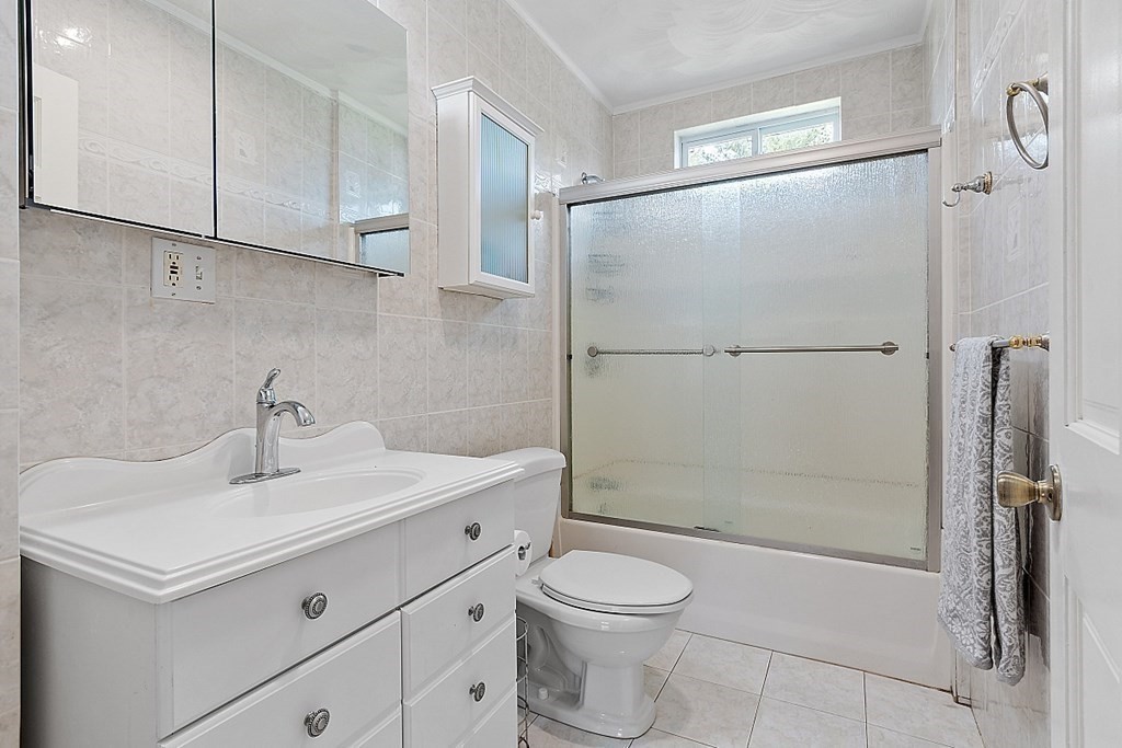 31 Booth Road Methuen, MA 01844 - Photo 27 of 38 a bathroom with a shower sink vanity and toilet