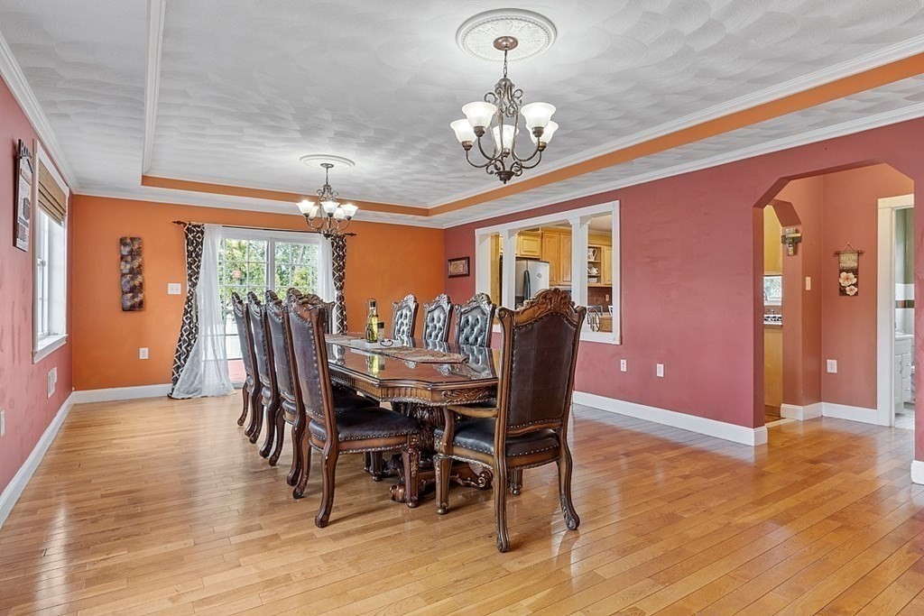 31 Booth Road Methuen, MA 01844 - Photo 7 of 38 a view of a dining room with furniture a chandelier and wooden floor