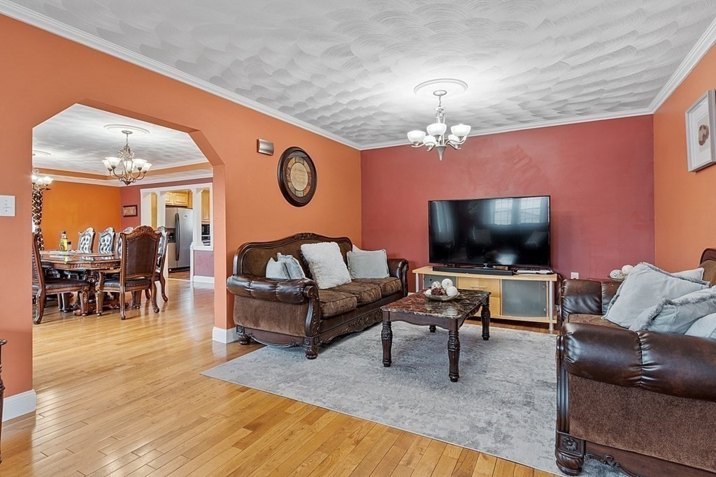 31 Booth Road Methuen, MA 01844 - Photo 10 of 38 a living room with furniture and a flat screen tv