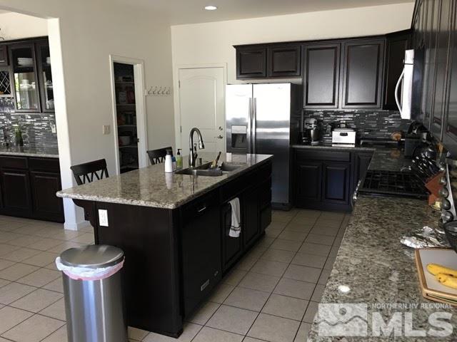 2233 Alivia Way Reno, NV 89521 - Photo 2 of 10 a kitchen with stainless steel appliances granite countertop a sink stove and refrigerator