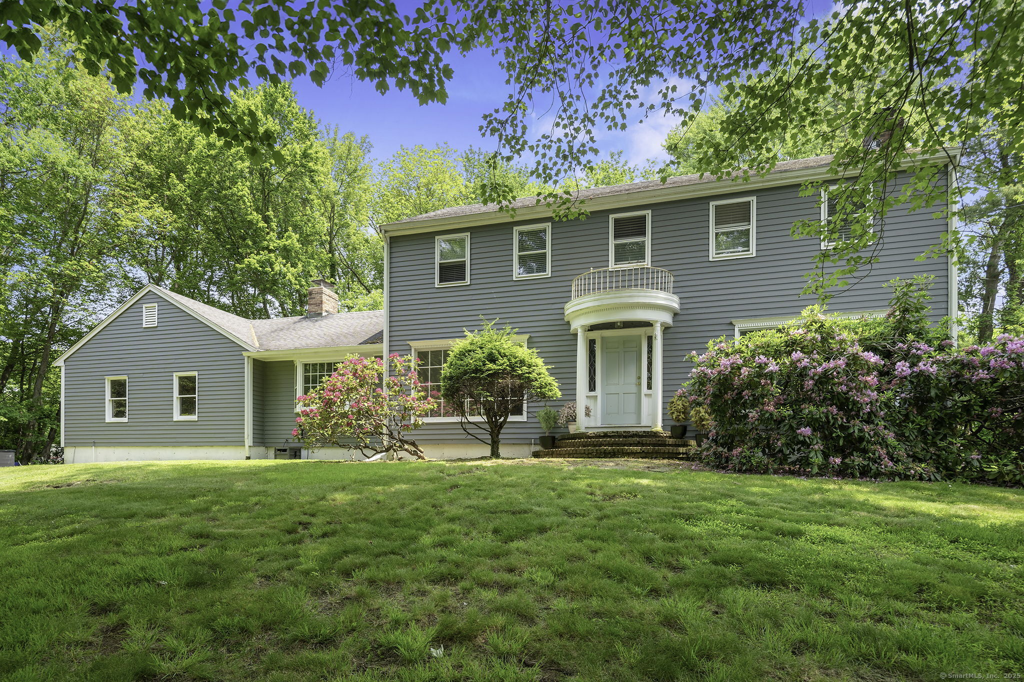 a front view of house with yard and green space