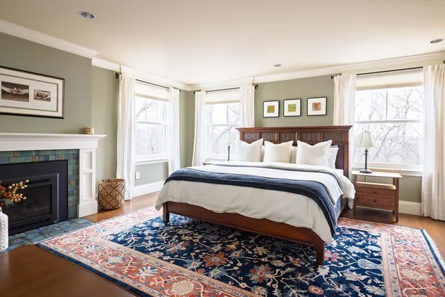 a bedroom with a bed and a fireplace