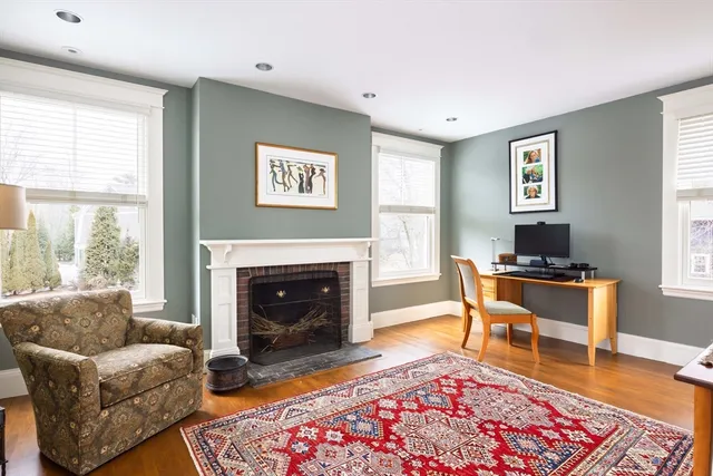 a living room with furniture a rug and a fireplace