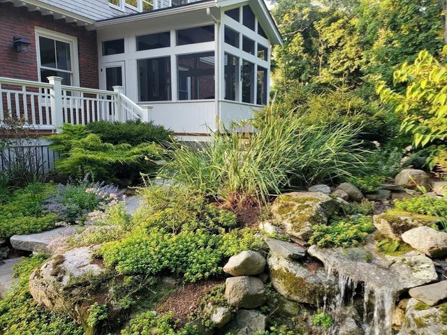 a view of a house with a flower garden