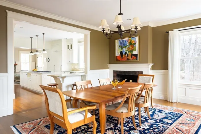 a dining room with furniture a chandelier and wooden floor