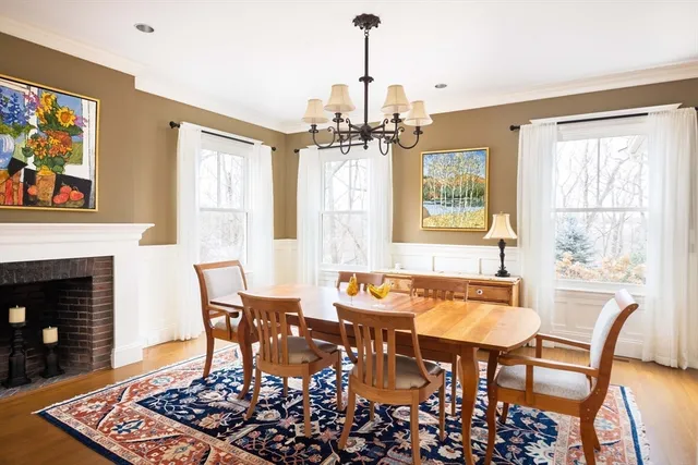 a dining room with furniture a chandelier and wooden floor
