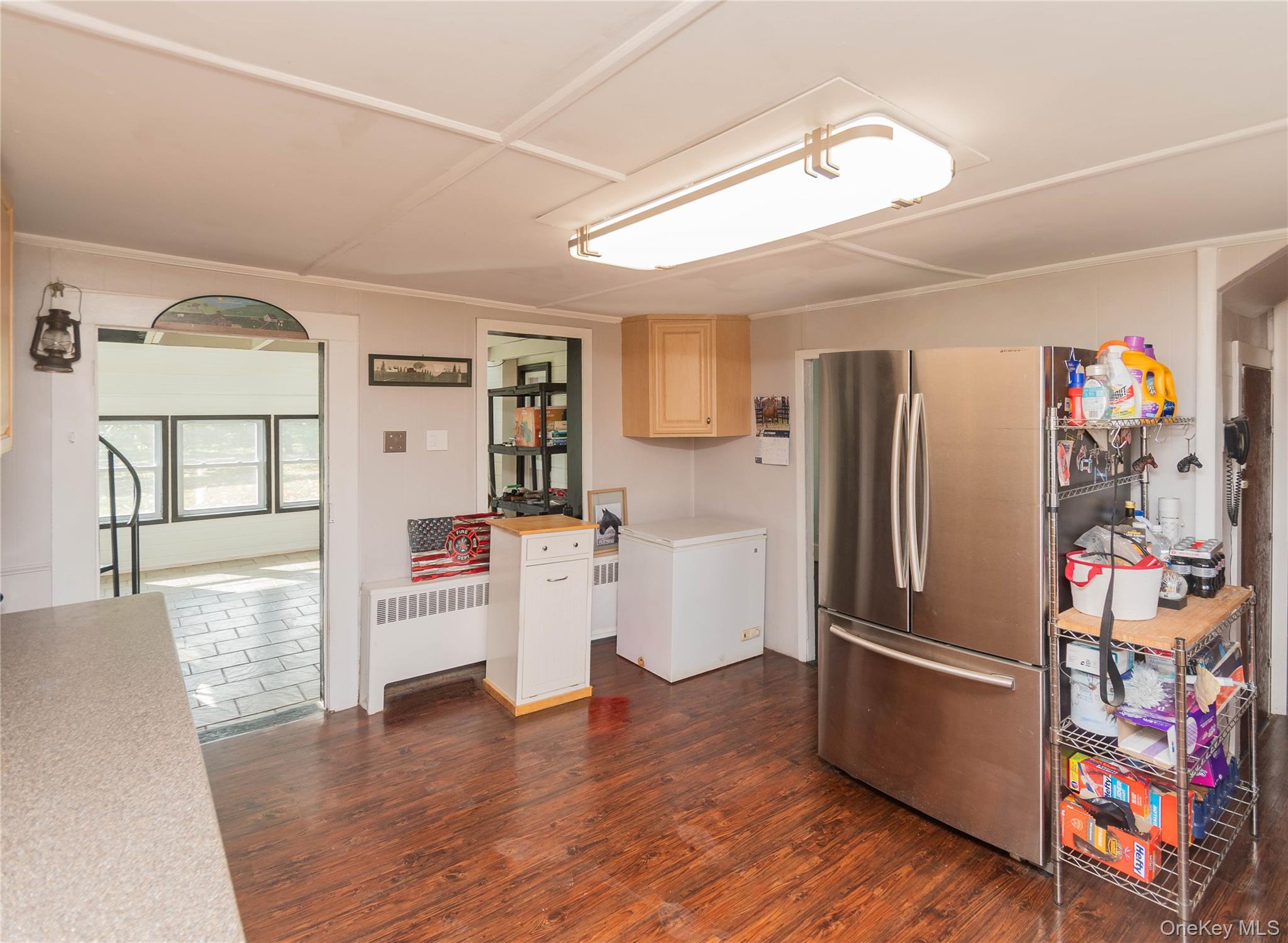 269 Orchard Road Highland, NY 12528 - Photo 6 of 24 Kitchen featuring light countertops, radiator, dark wood finished floors, freestanding refrigerator, and light brown cabinets