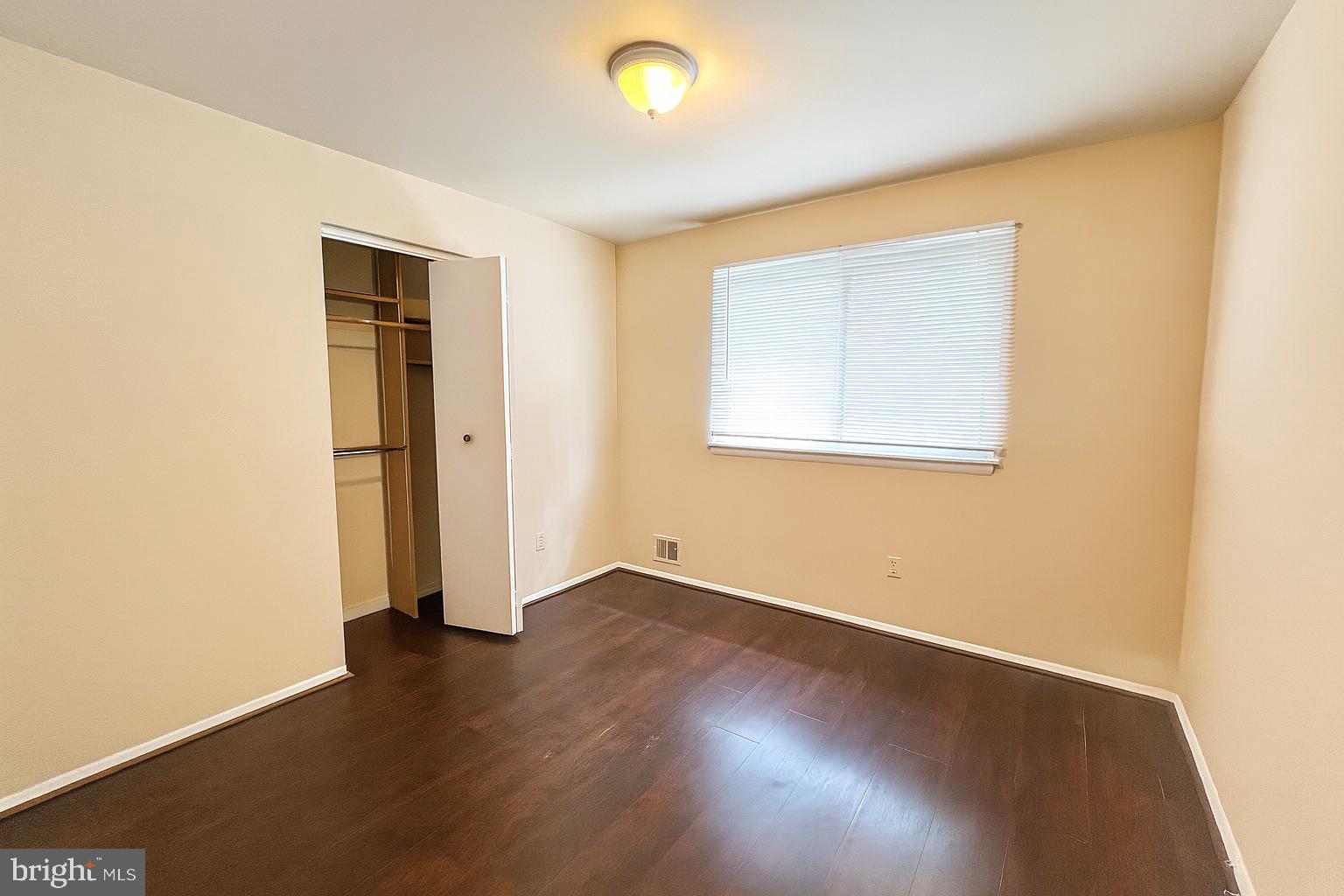 8702 Hamlin Street, Unit A Landover, MD 20785 - Photo 12 of 15 an empty room with wooden floor and windows