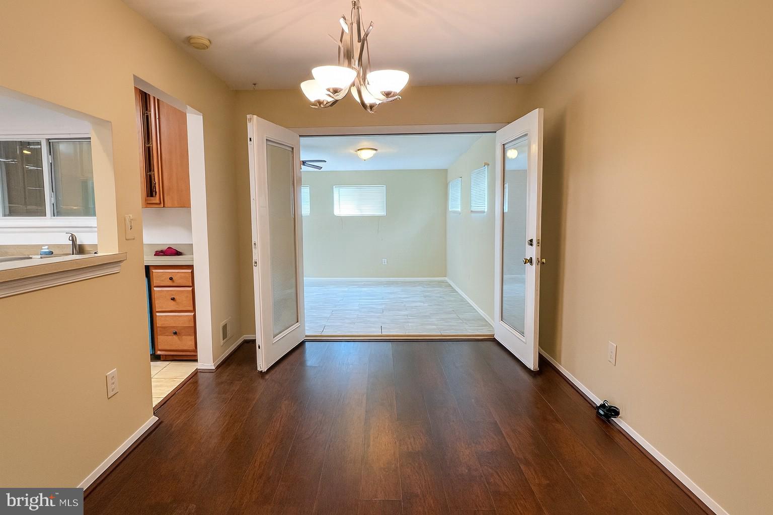 8702 Hamlin Street, Unit A Landover, MD 20785 - Photo 5 of 15 wooden floor in an empty room with a window
