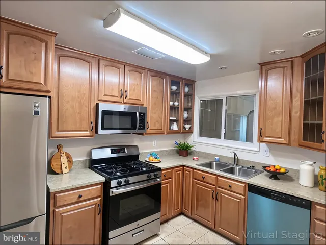 a kitchen with stainless steel appliances granite countertop a refrigerator stove and sink