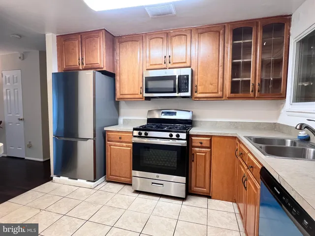 a view of a kitchen with a sink and a window