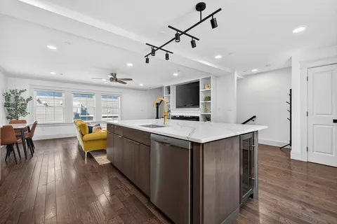 a kitchen with stainless steel appliances granite countertop a sink a stove and a refrigerator