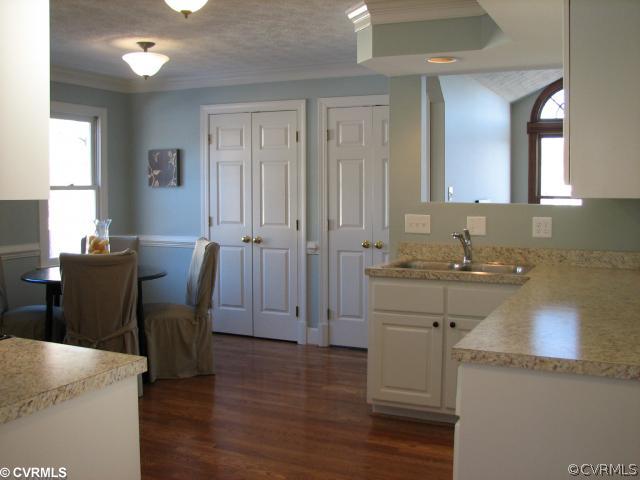 12011 Taplow Road Midlothian, VA 23112 - Photo 5 of 12 a view of a kitchen area with furniture and wooden floor